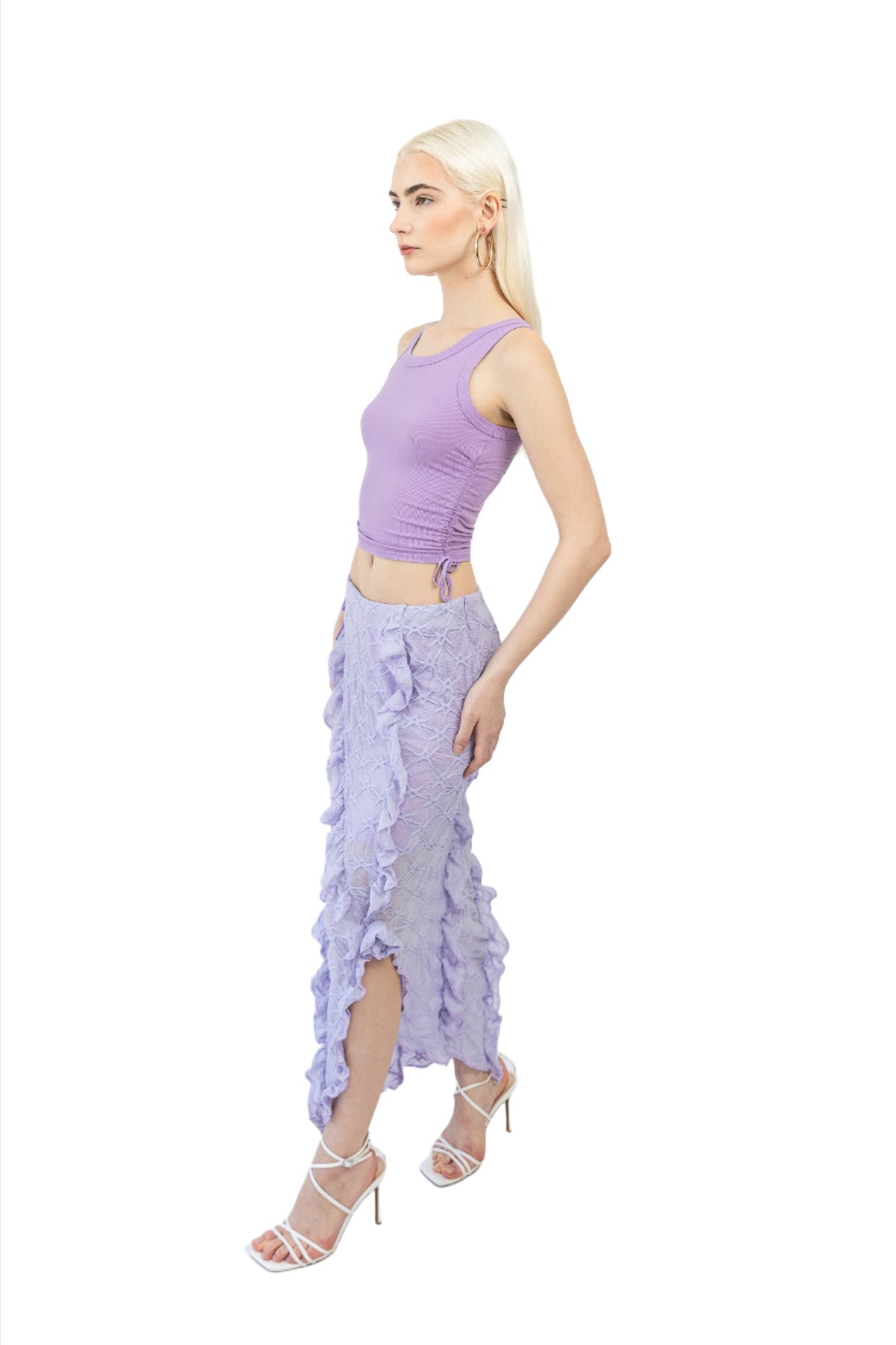 Model wears Mermaid Maxi Skirt in Lilac. Left side facing. Styled with a purple top.