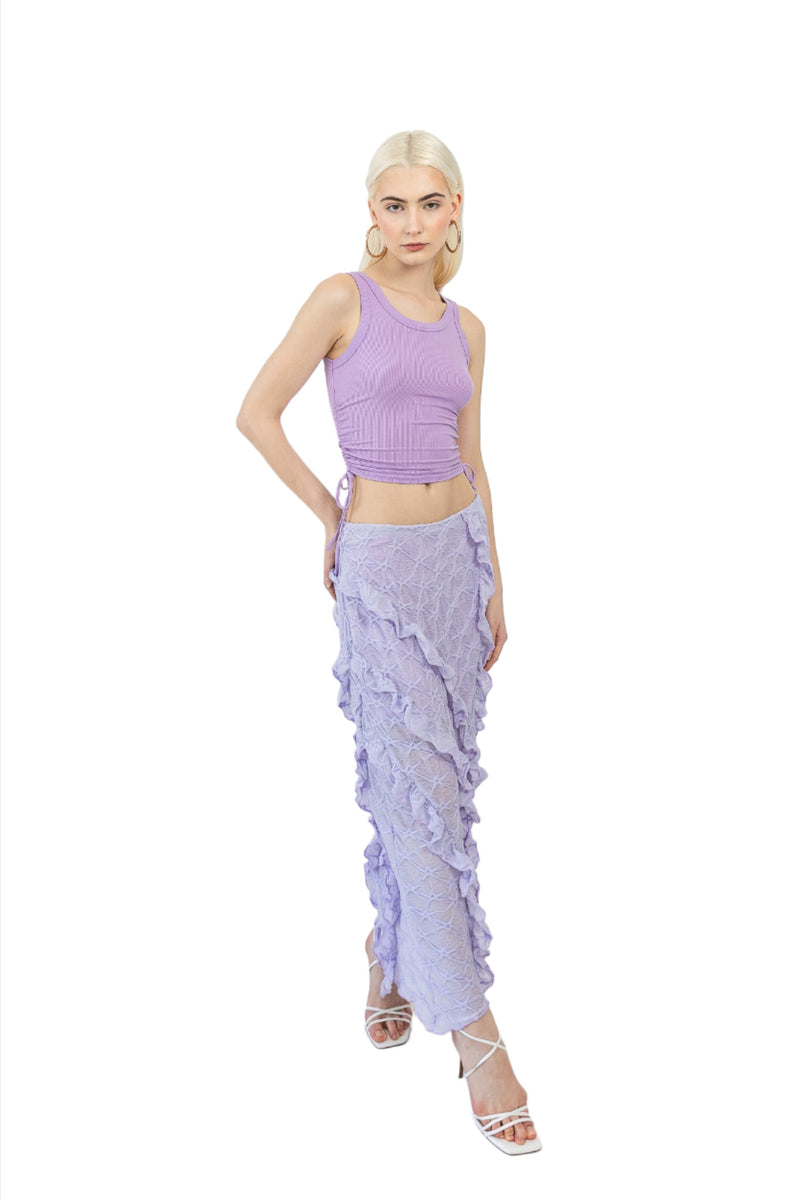 Model wears Mermaid Maxi Skirt in Lilac. Front and right side facing. Styled with a purple top.