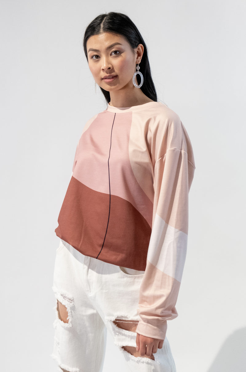 Model wearing a stylish patterned crewneck sweatshirt with a modern abstract design