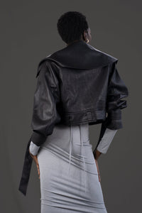 Model wearing the asym vegan leather oversized jacket. Size medium  Back side.