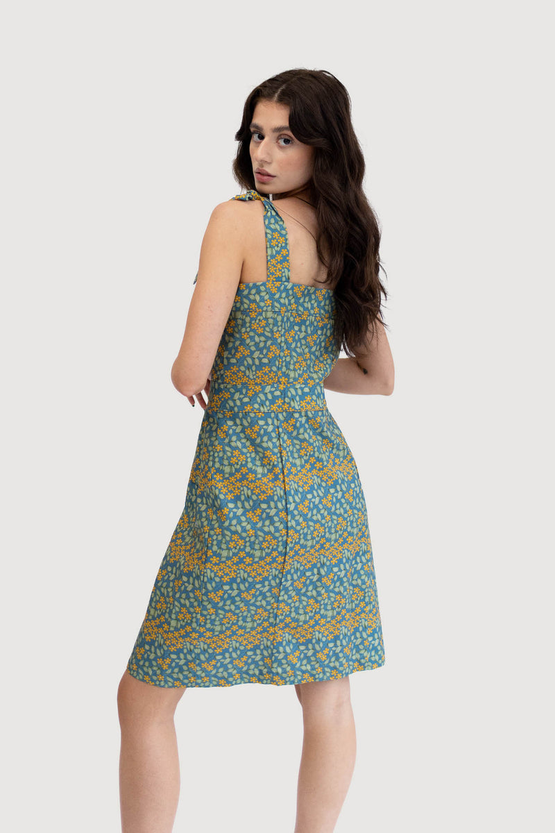 Model wearing the Margarita Sundress in night blue floral print.  Back side.
